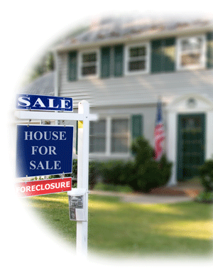 Photo of house with a for sale sign in front.